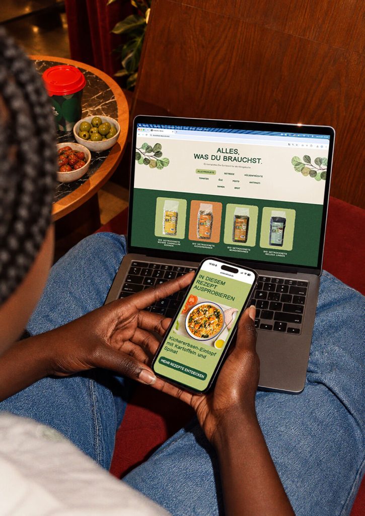 bioviafood.de on a laptop in a crate of red peppers, with BIOVIA logo and the line «Organic, now online»